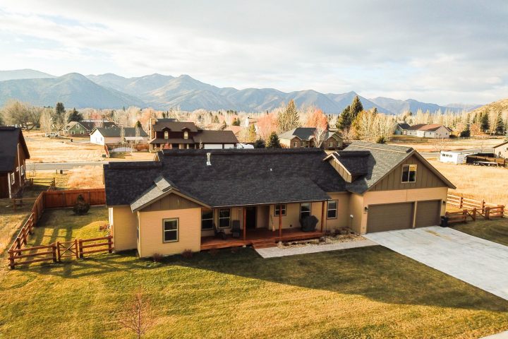 aerial shot of a brown home and front yard